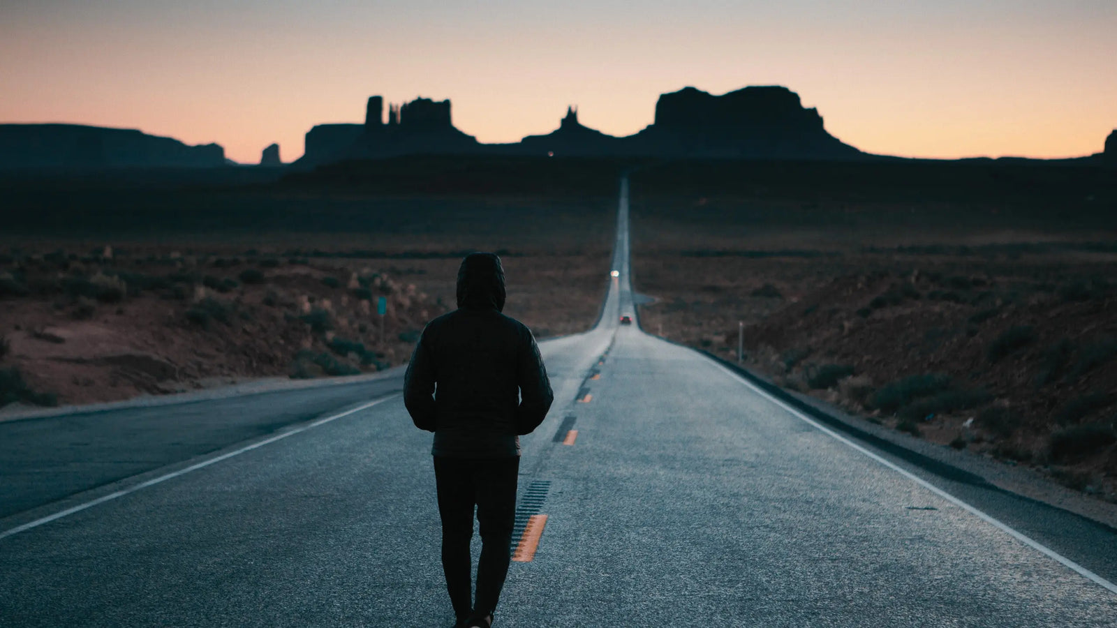 Techify™ symbolic journey showing a lone figure walking down a long road toward innovation and purpose.
